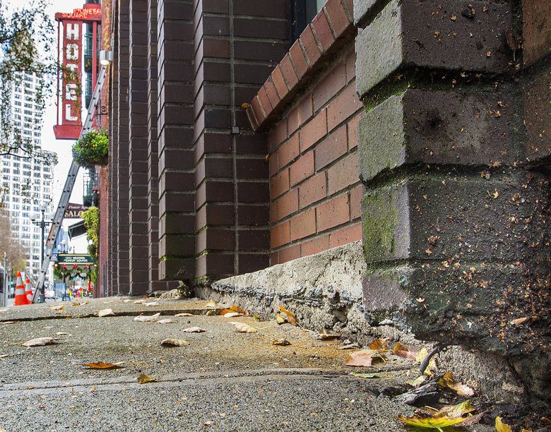 Cracks in sidewalks and buildings due to ground water pumping.